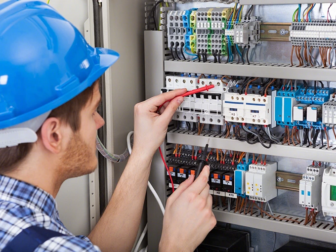 Electricians inspecting electrical equipment